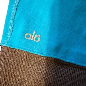 Alo Yoga gently worn yoga tights in turquoise and tan.  No size listed.